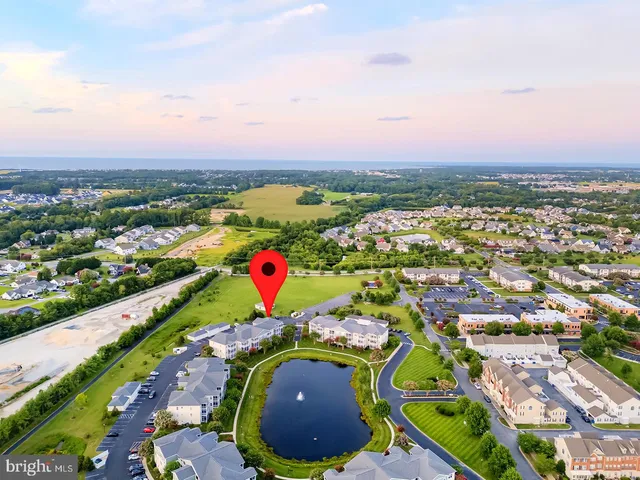 a living room with couches a dining table and chairs with wooden floor