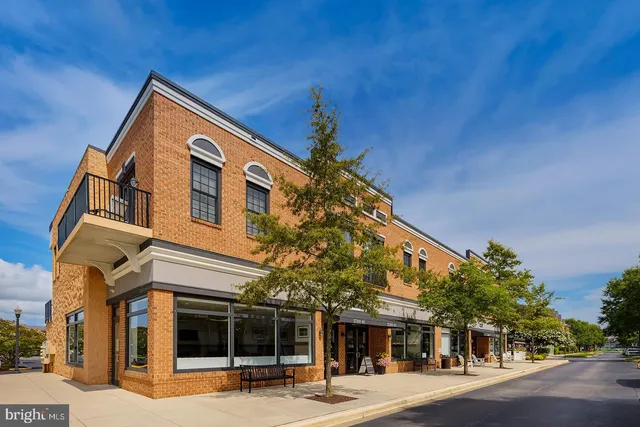 a view of a house with pool and chairs