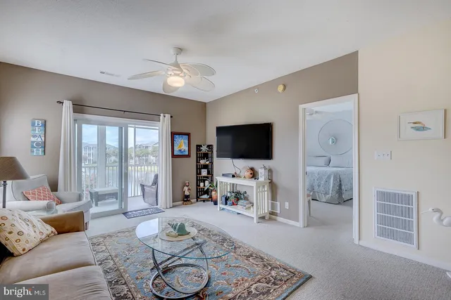 a view of a dining room with furniture and a chandelier