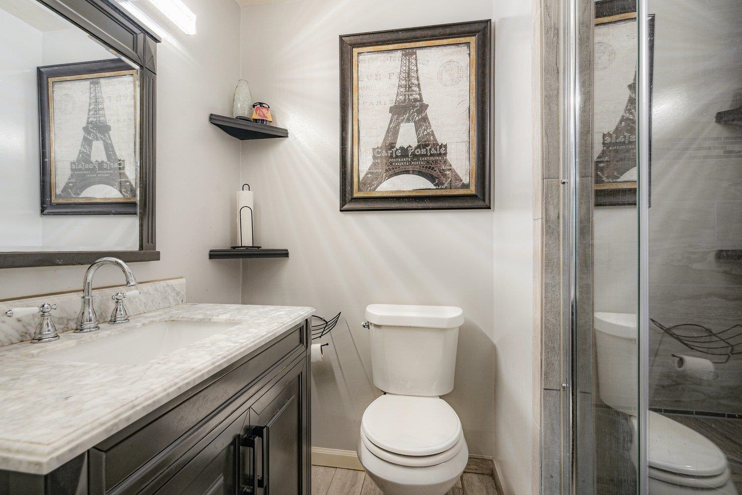 5040 Warrington Road Memphis, TN 38118 - Photo 21 of 29 Full bathroom featuring vanity, toilet, baseboards, and a shower stall