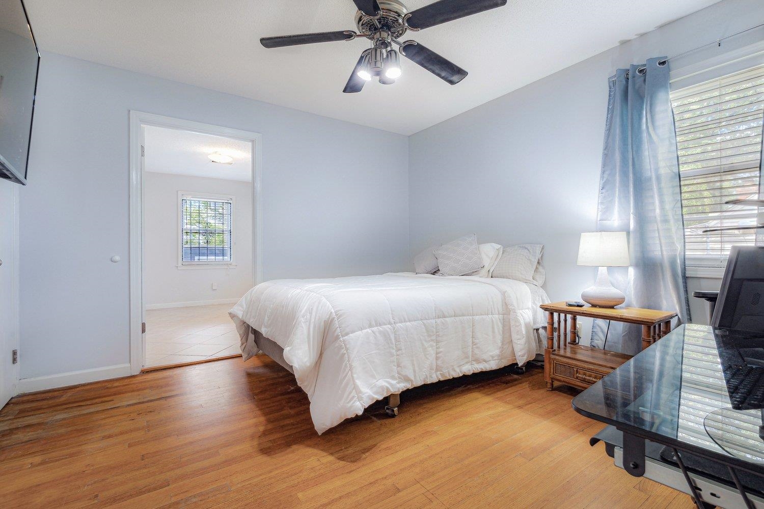 5040 Warrington Road Memphis, TN 38118 - Photo 22 of 29 Bedroom with light wood finished floors, baseboards, and a ceiling fan