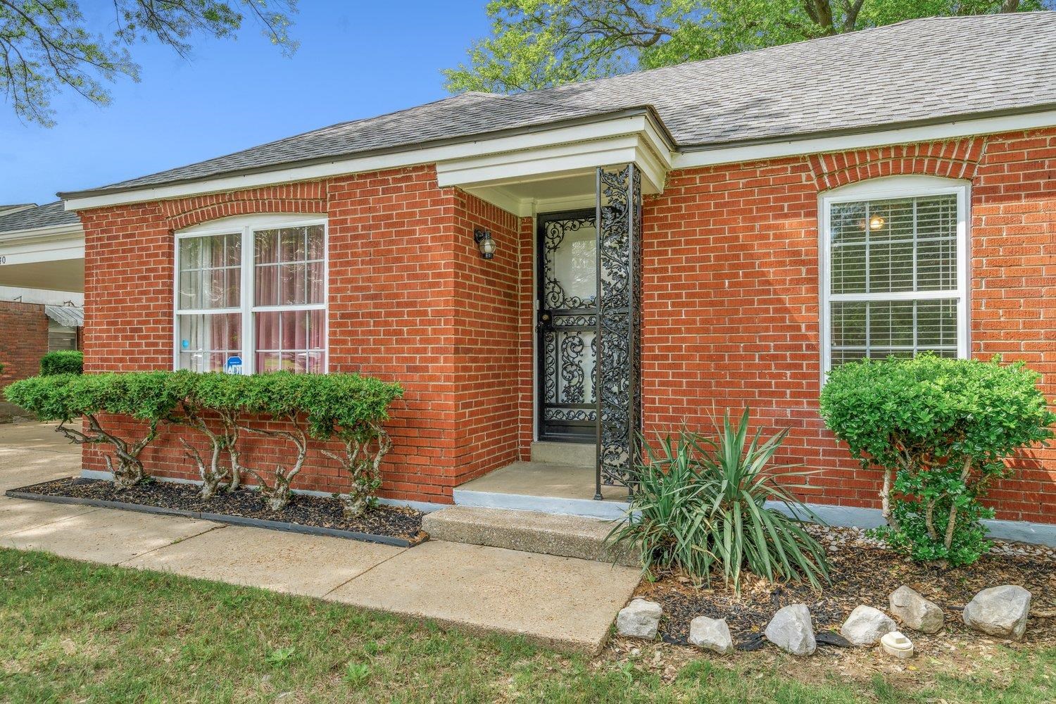 5040 Warrington Road Memphis, TN 38118 - Photo 4 of 29 Entrance to property featuring a shingled roof and brick siding