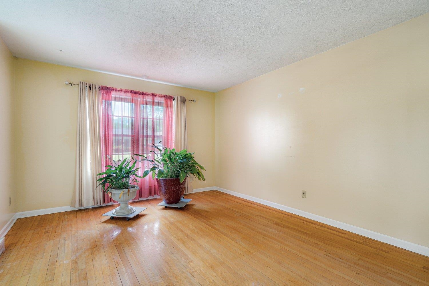 5040 Warrington Road Memphis, TN 38118 - Photo 7 of 29 Unfurnished room with a textured ceiling, baseboards, and wood-type flooring