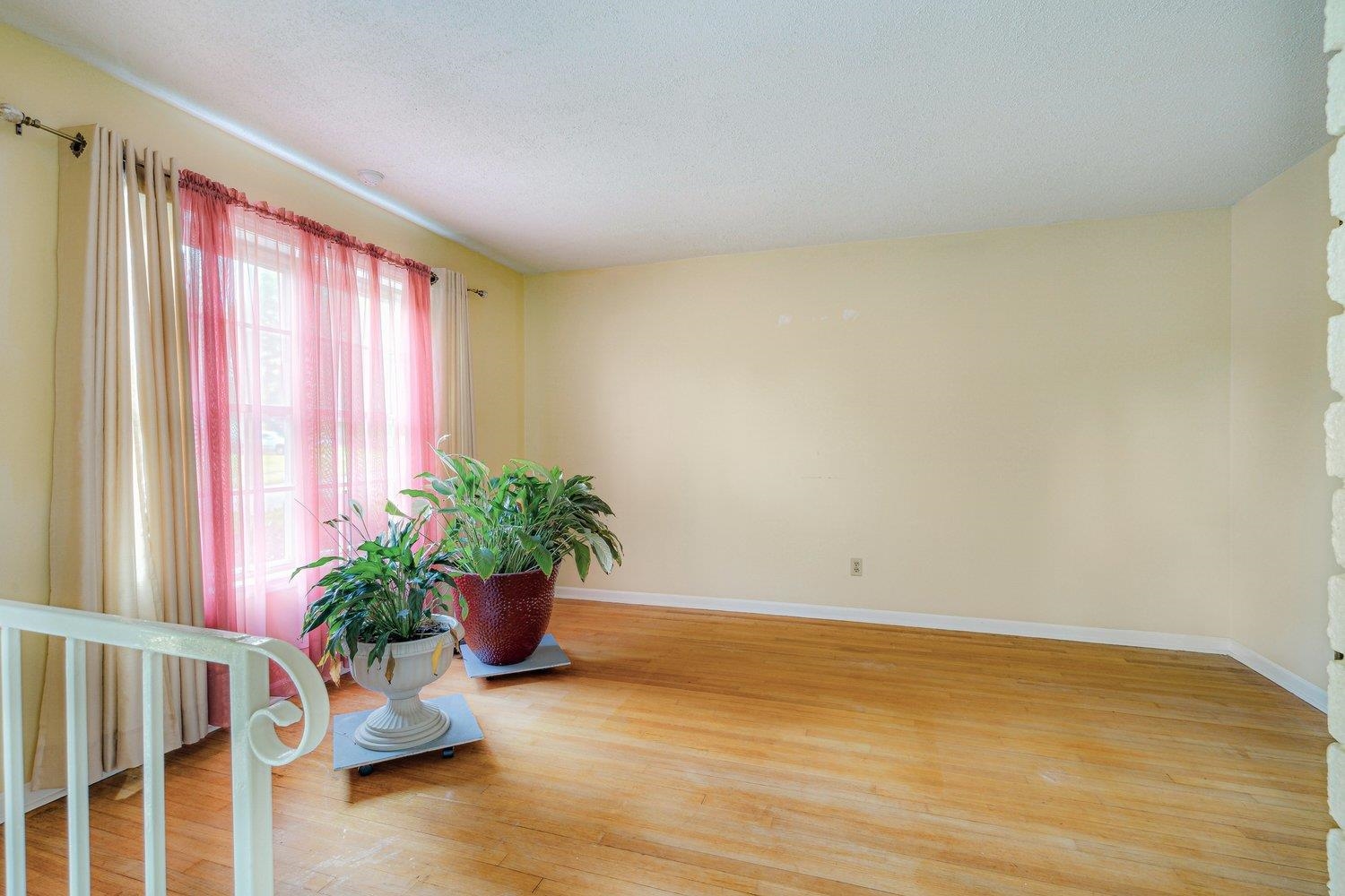 5040 Warrington Road Memphis, TN 38118 - Photo 8 of 29 Sitting room with light wood-style flooring, a textured ceiling, and baseboards
