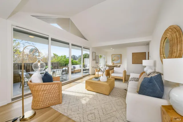 a living room with fireplace furniture and a large window