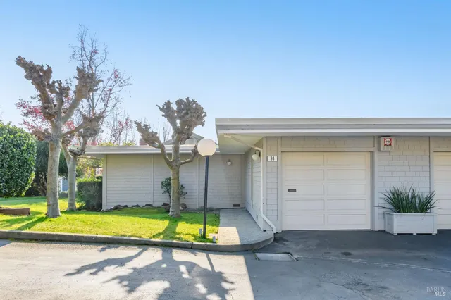 a view of a house with a yard and a patio
