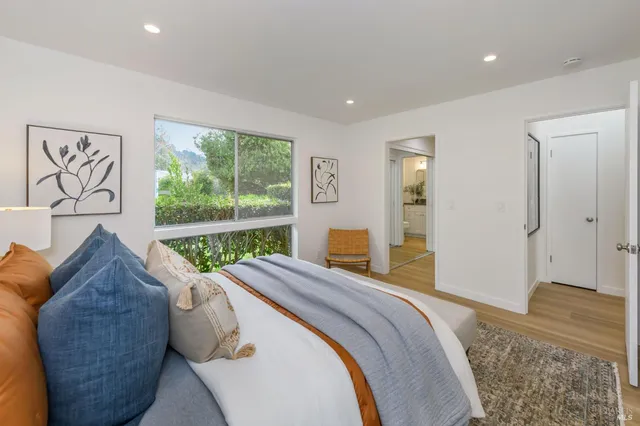 a bedroom with a bed and a large window