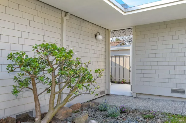 a couple of potted plants in front of door