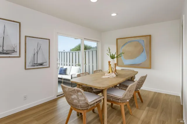 a dining room with furniture and wooden floor