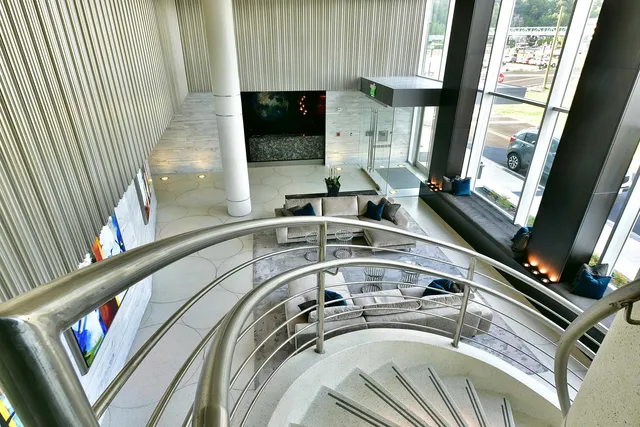 a work room with furniture and large windows