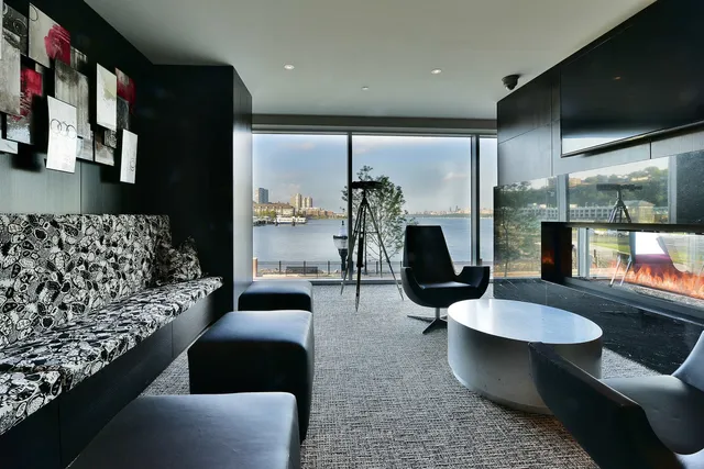 a living room with furniture and a floor to ceiling window