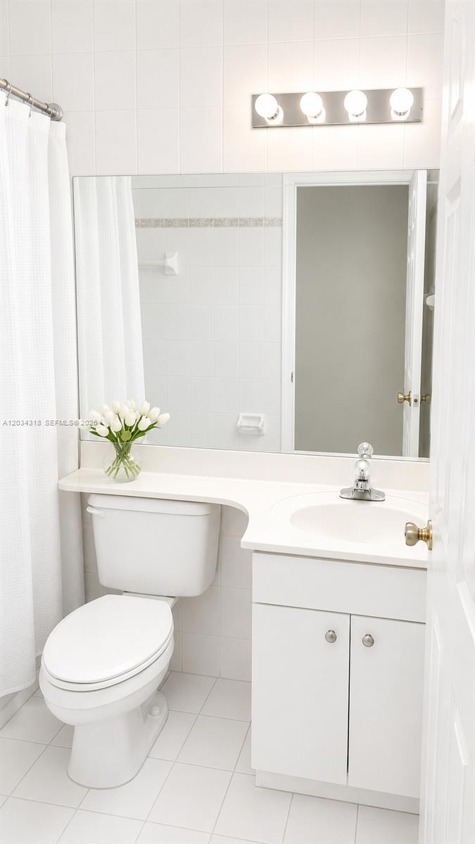 14856 Southwest 179th Street Miami, FL 33187 - Photo 28 of 33 a bathroom with a sink a toilet and a mirror