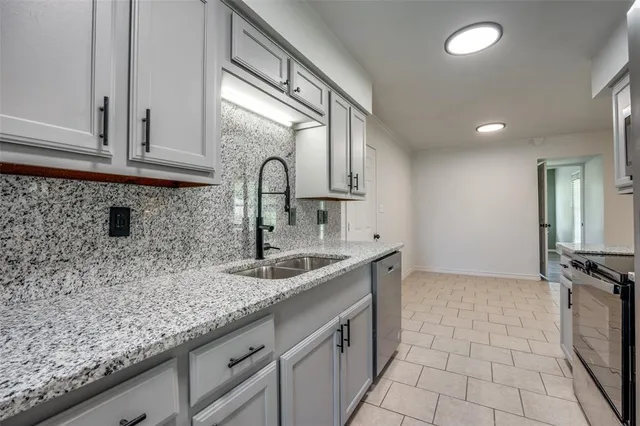 a kitchen with a sink and cabinets