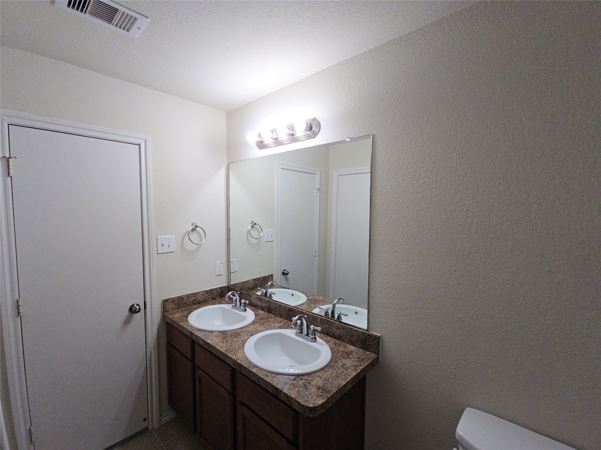 810 Lightningbug Lane Conroe, TX 77301 - Photo 10 of 27 a bathroom with a granite countertop sink and a mirror