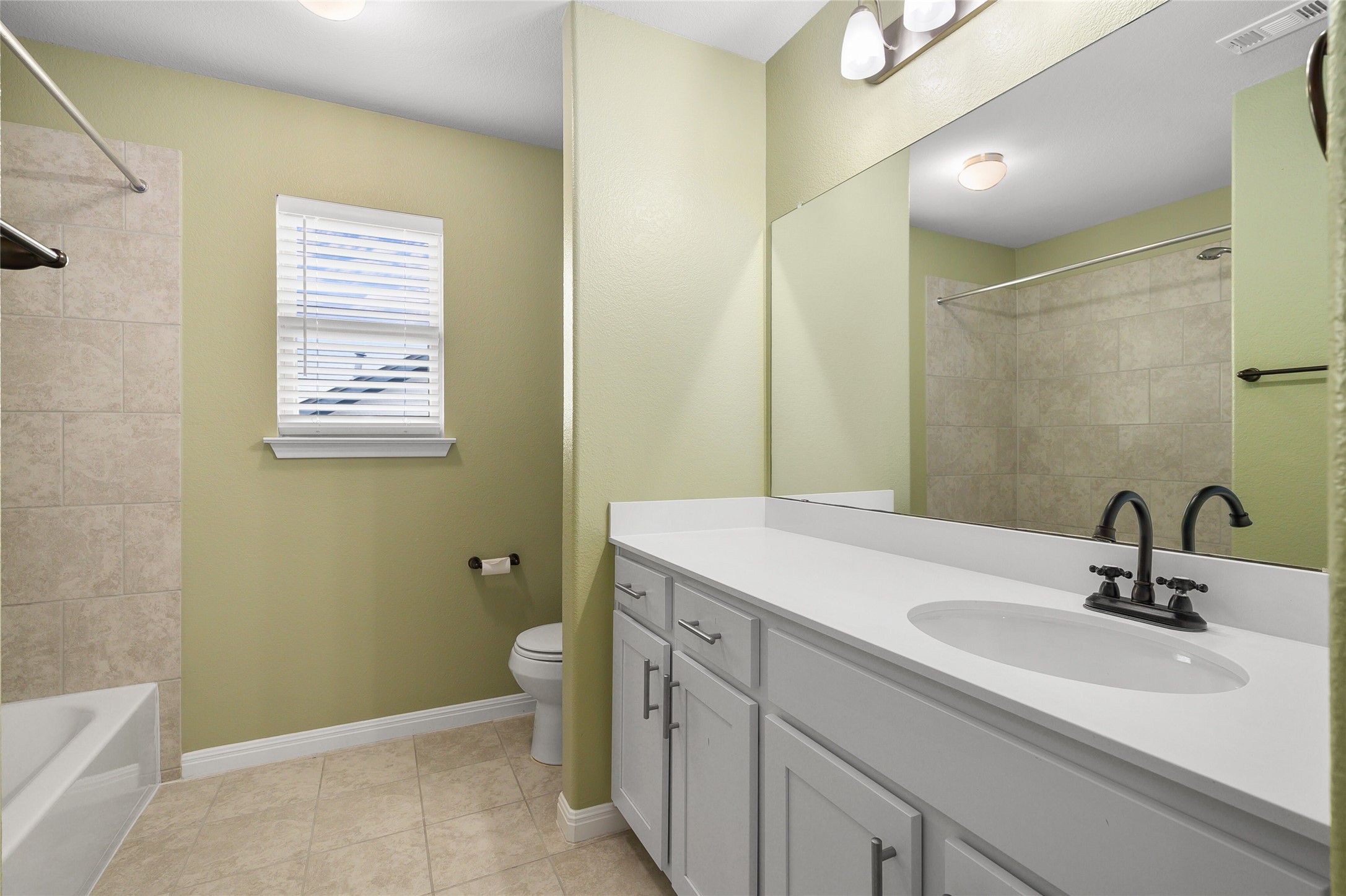 101 Lambert Street Leander, TX 78641 - Photo 26 of 33 A pristine bathroom features a single vanity, a well-lit mirror, and a convenient window.