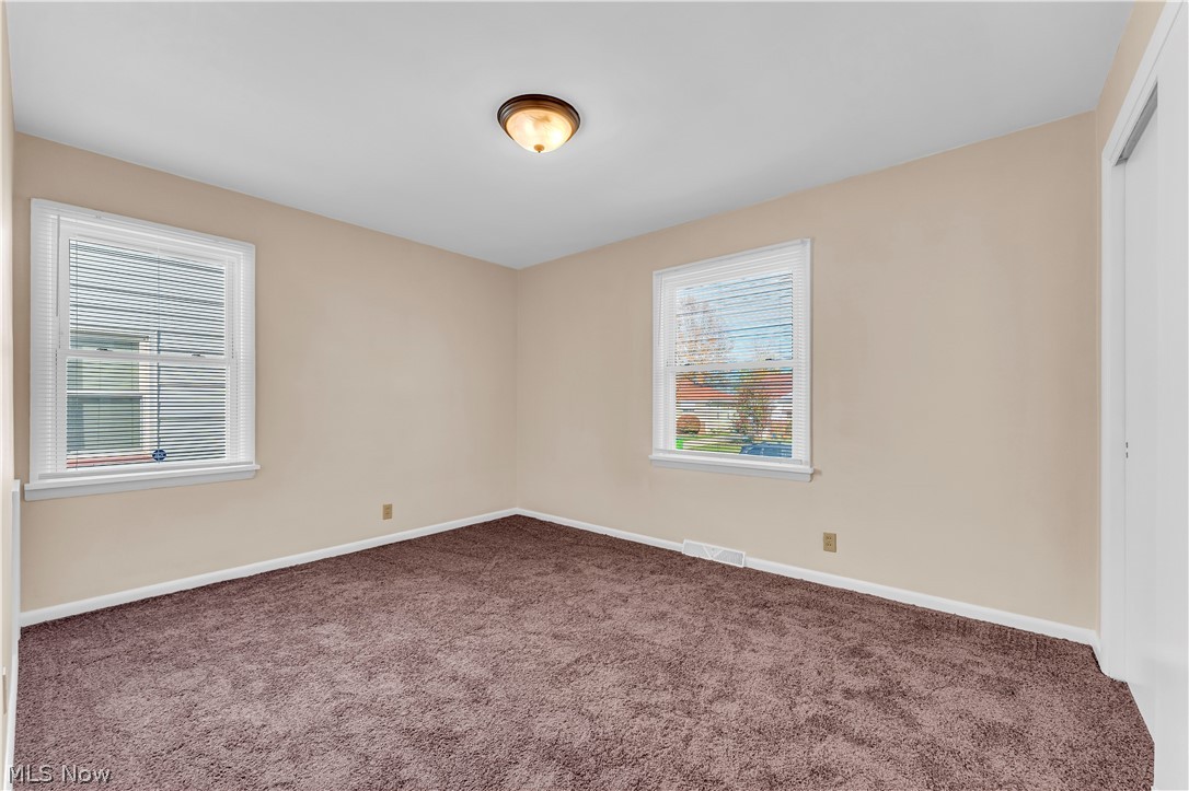9716 Alexander Road Cleveland, OH 44125 - Photo 10 of 30 Empty room with dark carpet and baseboards