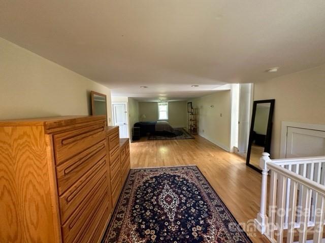 34 Coosa Rdg Drive Whittier, NC 28789 - Photo 22 of 44 a view of a hallway with wooden floor and furniture