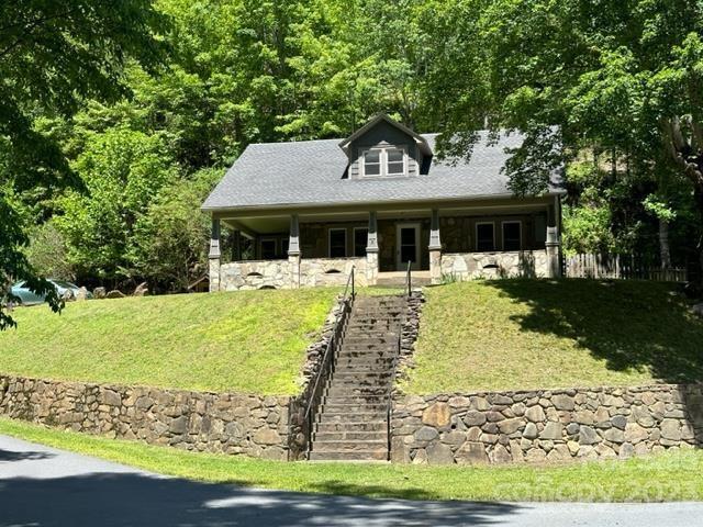 34 Coosa Rdg Drive Whittier, NC 28789 - Photo 3 of 44 a front view of a house with garden