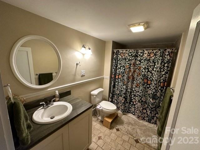 34 Coosa Rdg Drive Whittier, NC 28789 - Photo 37 of 44 a bathroom with a granite countertop toilet sink and mirror