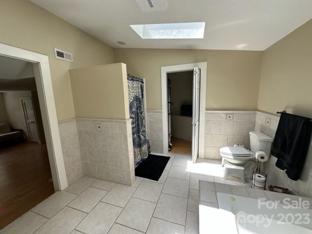 34 Coosa Rdg Drive Whittier, NC 28789 - Photo 39 of 44 a bathroom with a toilet and a shower
