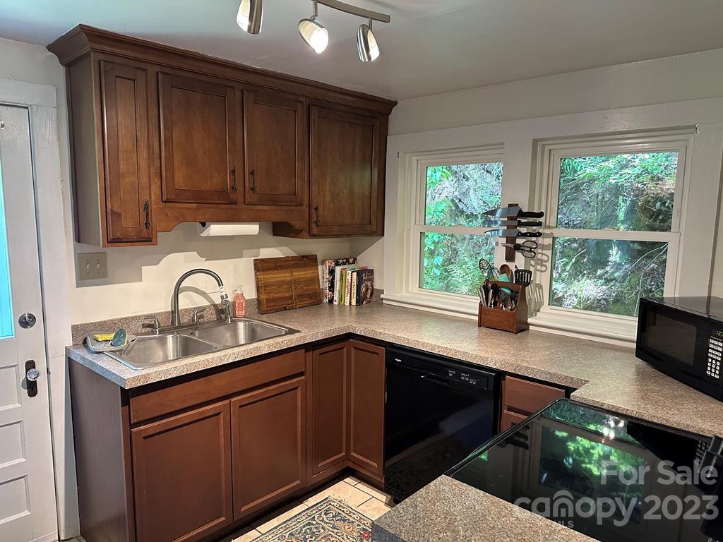 34 Coosa Rdg Drive Whittier, NC 28789 - Photo 7 of 44 a kitchen with kitchen island granite countertop a sink cabinets and window