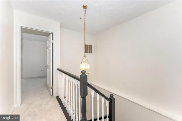 a view of a hallway view with staircase