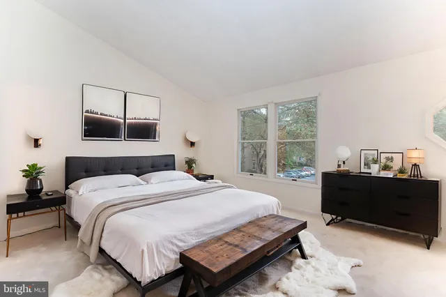 a bedroom with a bed and a window