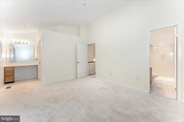 an empty room with closet and a bathroom