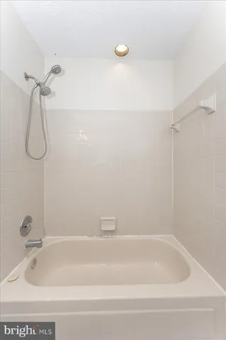 a bathroom with a bath tub with a shower