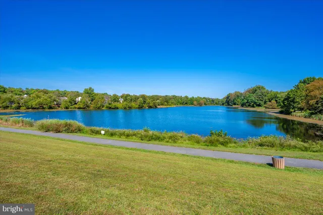 a view of a lake with houses in the back