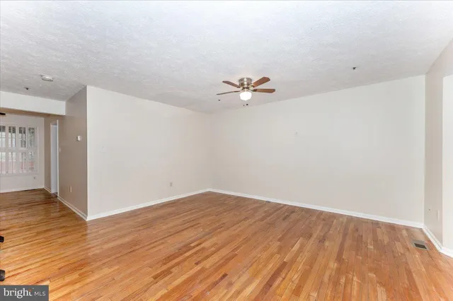 a view of a room with wooden floor
