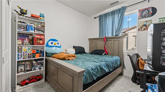 a bedroom with bed and a book shelf