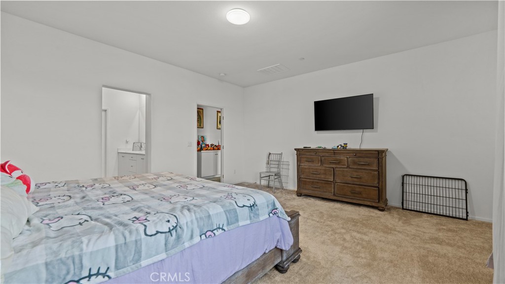 5604 Altamura Way, Unit 8 Fontana, CA 92336 - Photo 14 of 18 a bedroom with a bed and a flat screen tv