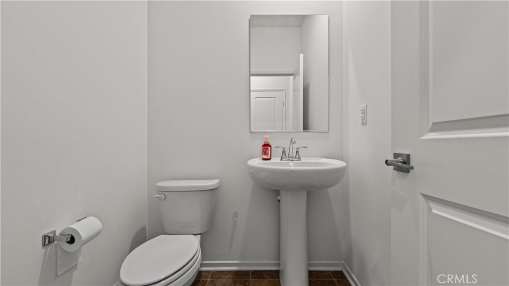 5604 Altamura Way, Unit 8 Fontana, CA 92336 - Photo 16 of 18 a bathroom with a sink toilet and a mirror
