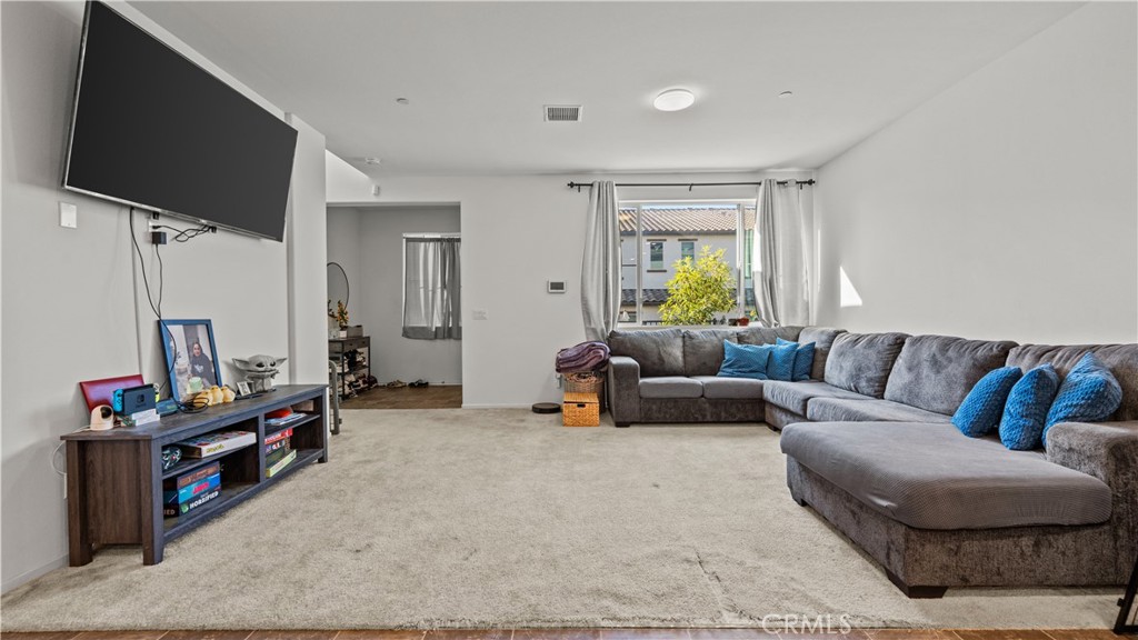 5604 Altamura Way, Unit 8 Fontana, CA 92336 - Photo 6 of 18 a living room with furniture a flat screen tv and a window