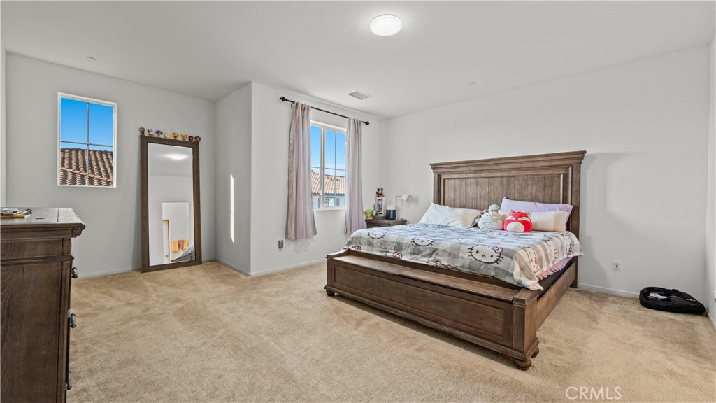 5604 Altamura Way, Unit 8 Fontana, CA 92336 - Photo 9 of 18 a bedroom with a bed and a table