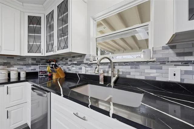 a kitchen with a sink appliances and cabinets