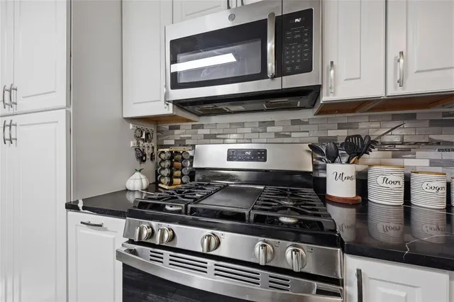 a kitchen with a stove and a microwave
