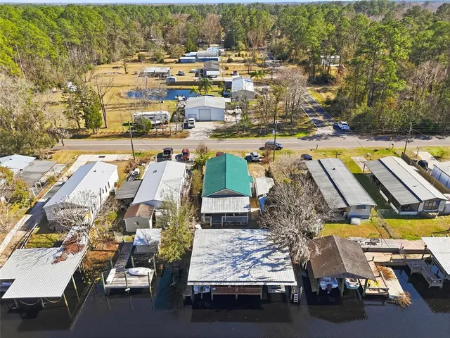 an aerial view of residential houses with yard