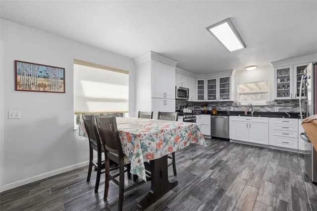 a large kitchen with a table and chairs