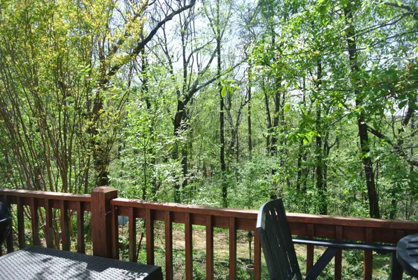 a view of a wooden fence and trees