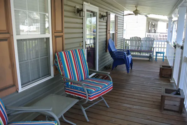 a outdoor living space with furniture and a flat screen tv