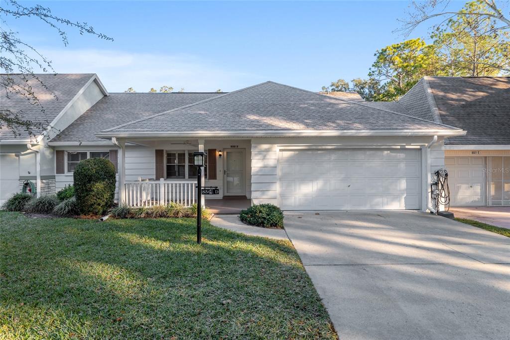 a front view of a house with a yard and porch