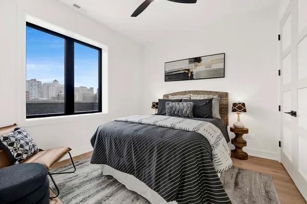 a bedroom with a bed and wooden floor