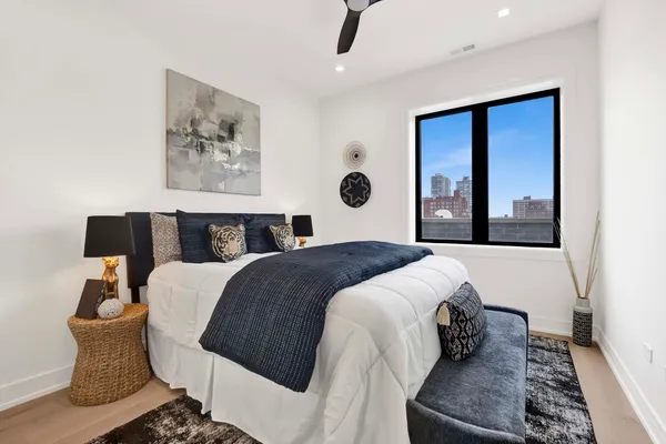 a bedroom with a large bed and a window