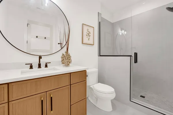 a bathroom with a toilet a sink and mirror