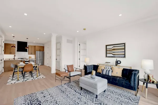 a living room with furniture and wooden floor
