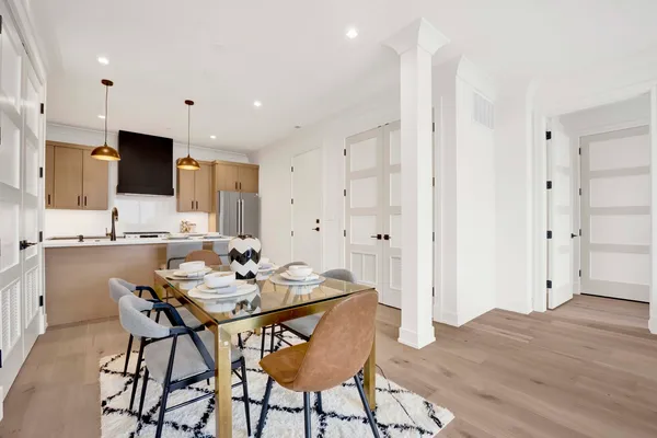 a view of a dining room with furniture and wooden floor