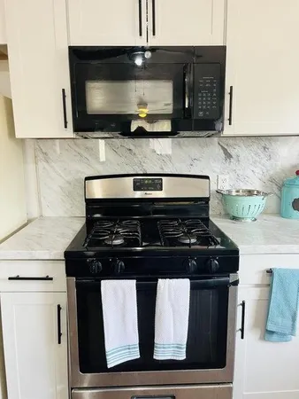 a kitchen with a stove and a microwave