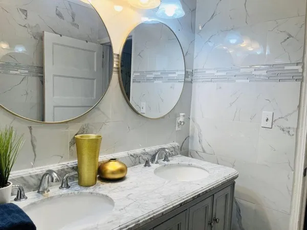 a bathroom with a granite countertop sink and a mirror